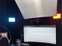 a bed with a computer and a monitor