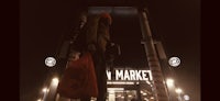 a statue of a man holding a bag in front of a new market