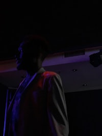 the silhouette of a man standing in a dark room